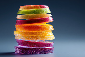 Stacked citrus slices with water droplets on blue background, a Food & Drink Photo by AlyaAnd