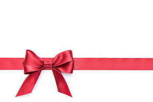 Red bow and ribbon creating a gift concept, a Holiday Photo by Olena Rudo