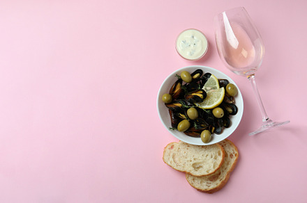 Concept of delicious food with mussels on pink background, a Food & Drink Photo by AtlasStudio