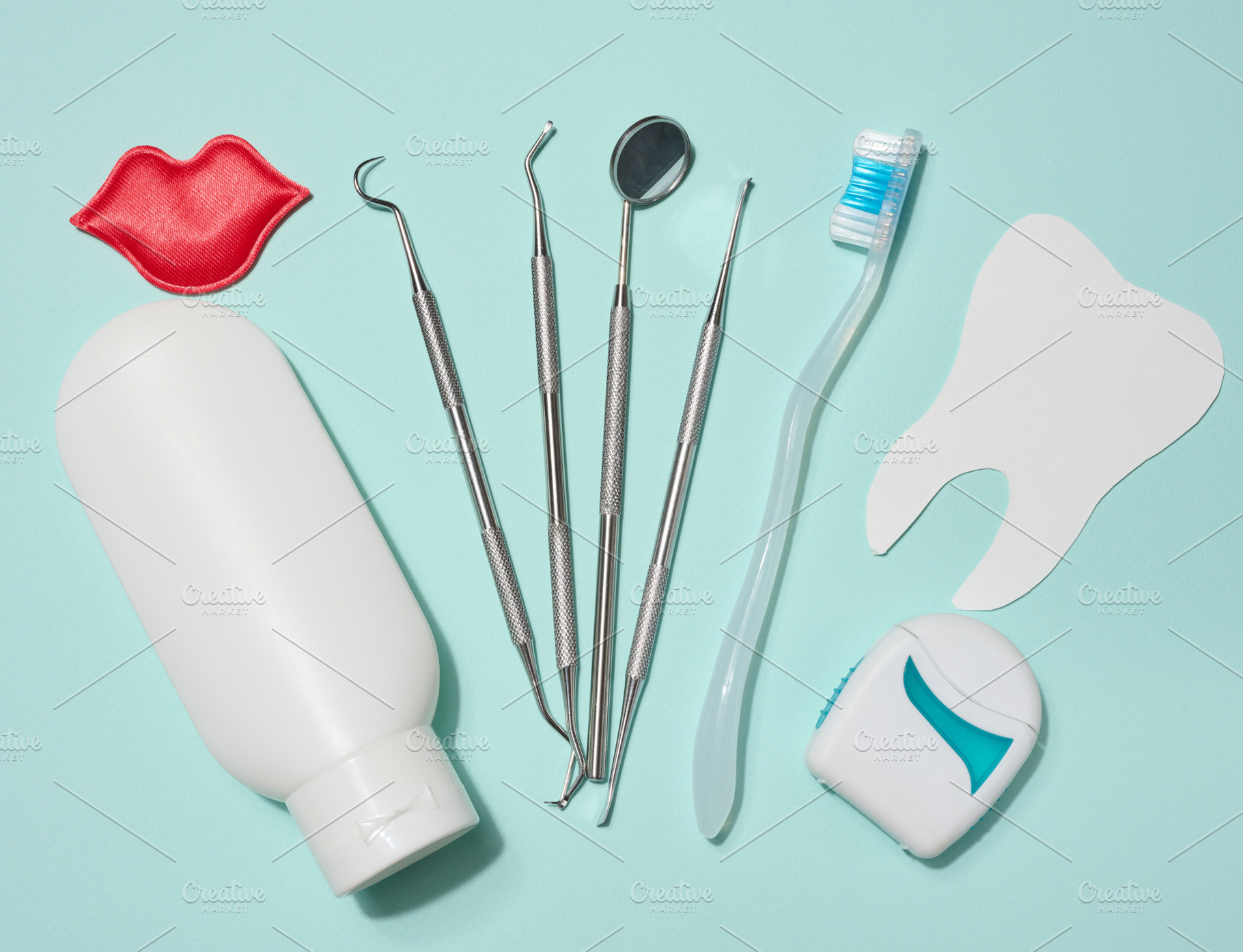 Red decorative lips, white tube of toothpaste, dental floss in w, a Health & Medical Photo by ndanko