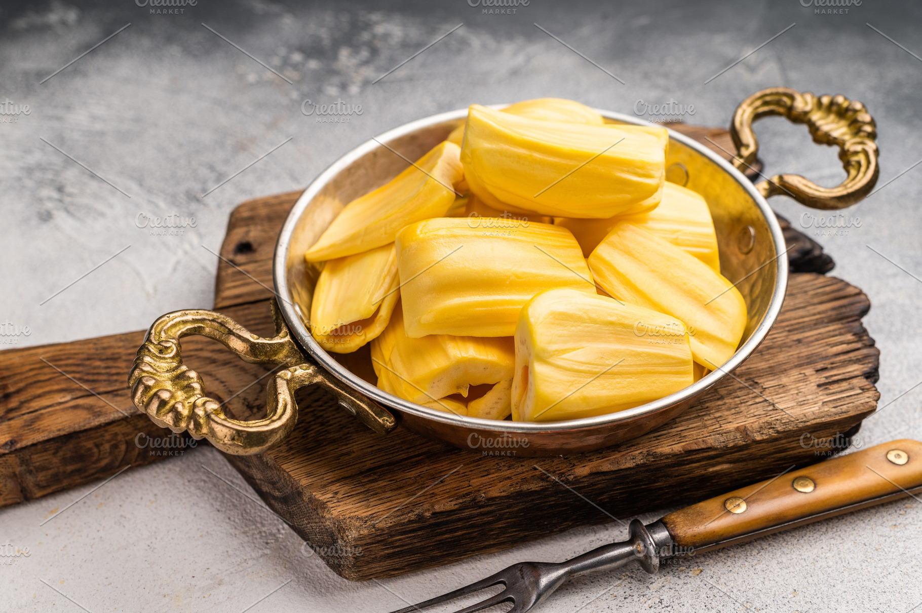 Sweet, golden jackfruit pods (bulbs) in a traditional metal bowl, a Photo by composter-box@mail.ru