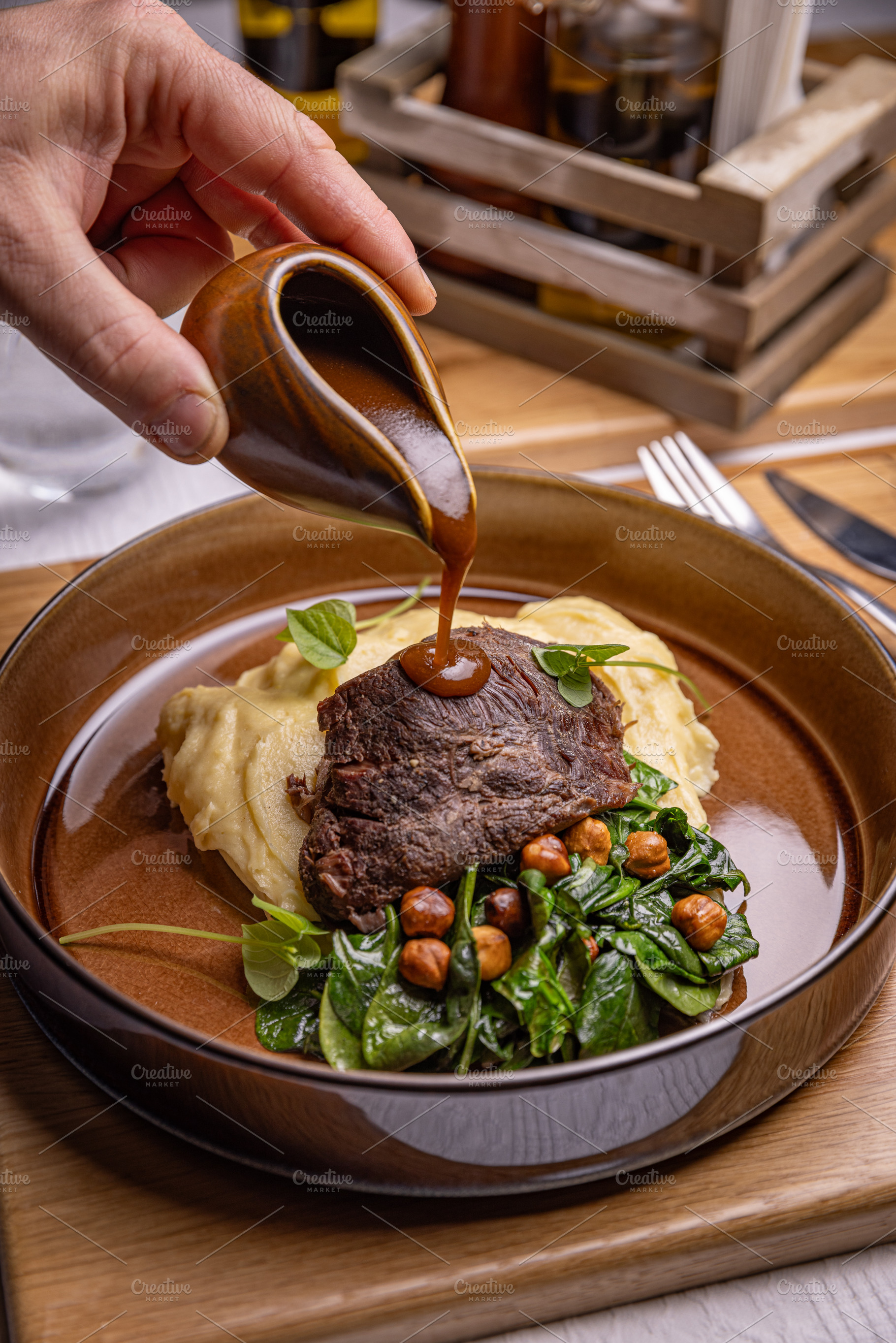 Chef pouring gravy on roasted beef, a Photo by Grafvision photography