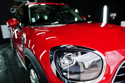 Headlights and hood of sport red car in garage., a Transportation Photo by AS photostudio