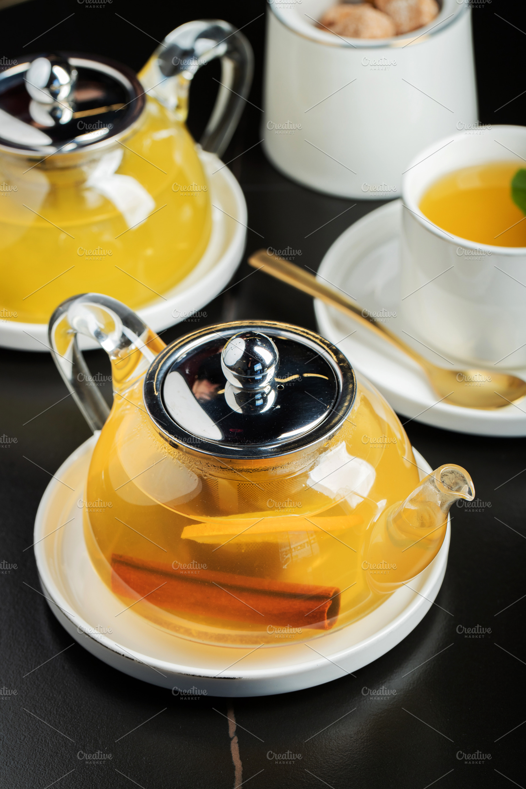 Fruit tea with mango and mint in a glass teapot on the table, a Food & Drink Photo by Budarinphoto