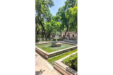 Tranquil park fountain with lush, a Nature Photo by Lermont51