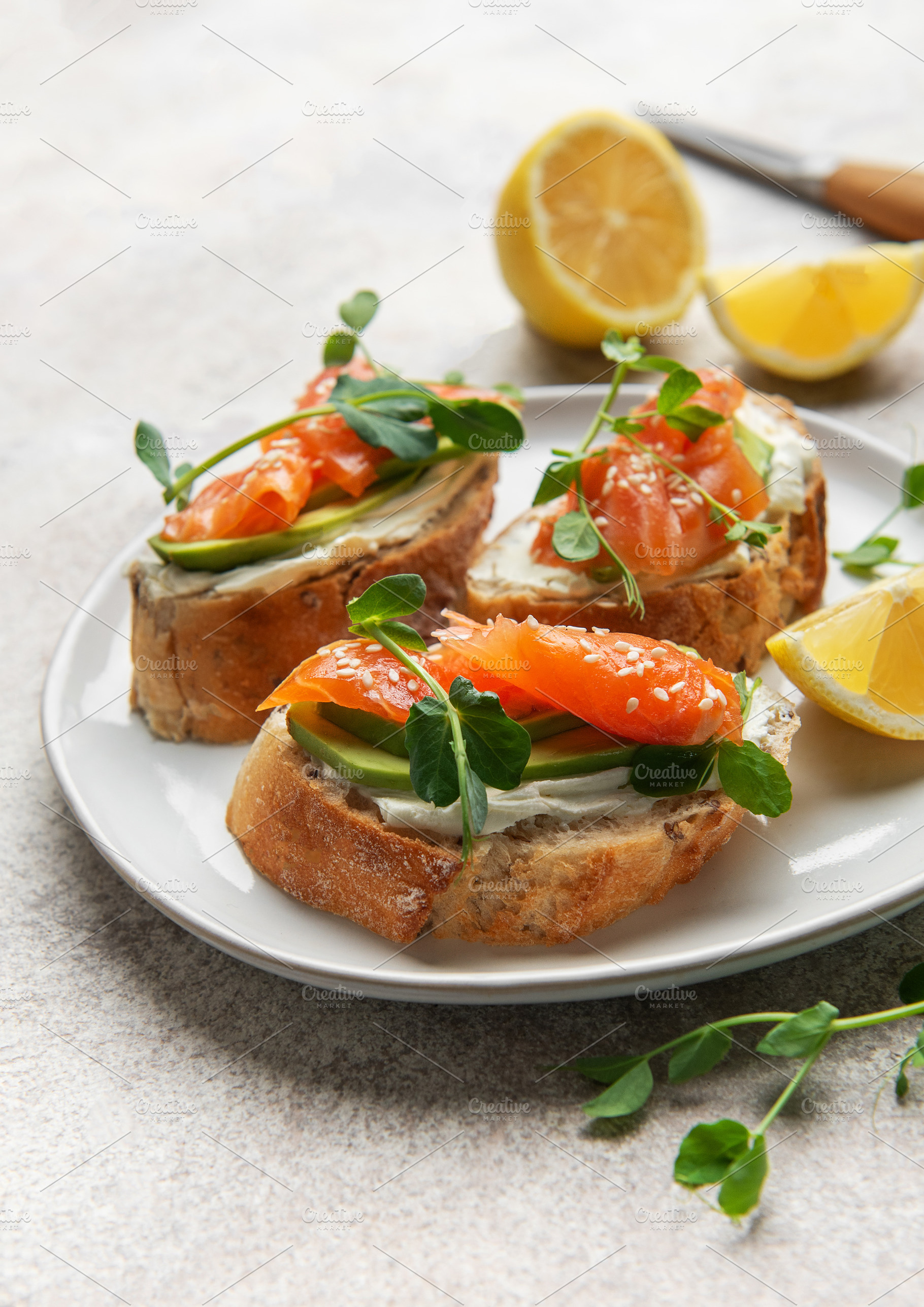 Smoked salmon bruschetta with avocado, cream cheese, and microgr, a Food & Drink Photo by Olena Rudo