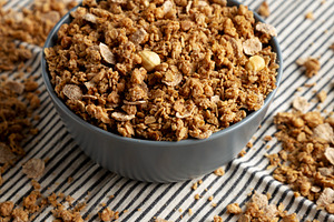 Healthy Homemade Toasted Muesli with Nuts in a Bowl, side view., a Food & Drink Photo by LiudmylaChuhunova