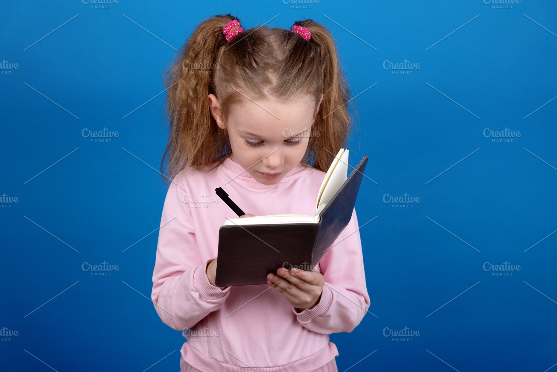 Child Writing in Notebook, a Person Photo by Ales Munt