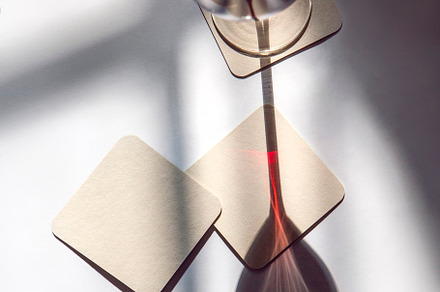 glass of red wine with coasters, a Photo by UN-BRANDED