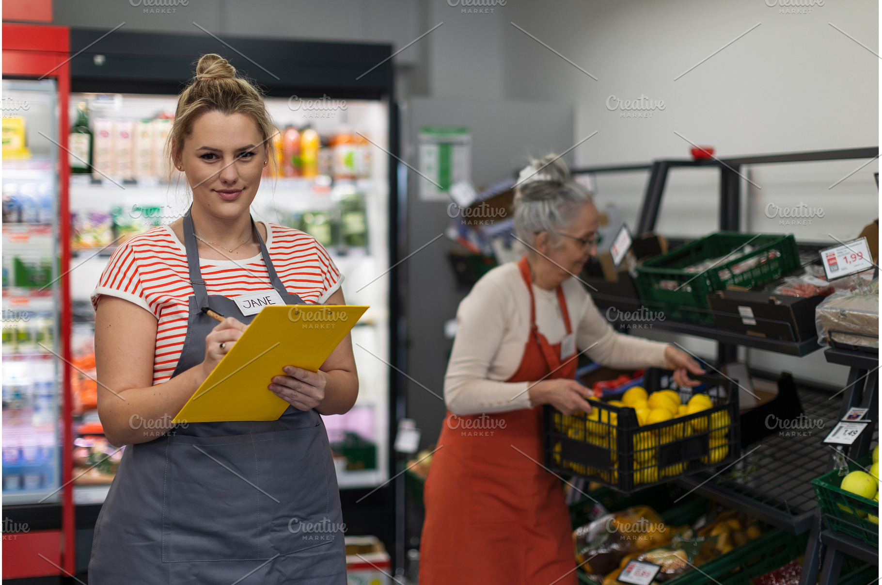 Young shop assistant in supermarket, a Person Photo by HalfPoint