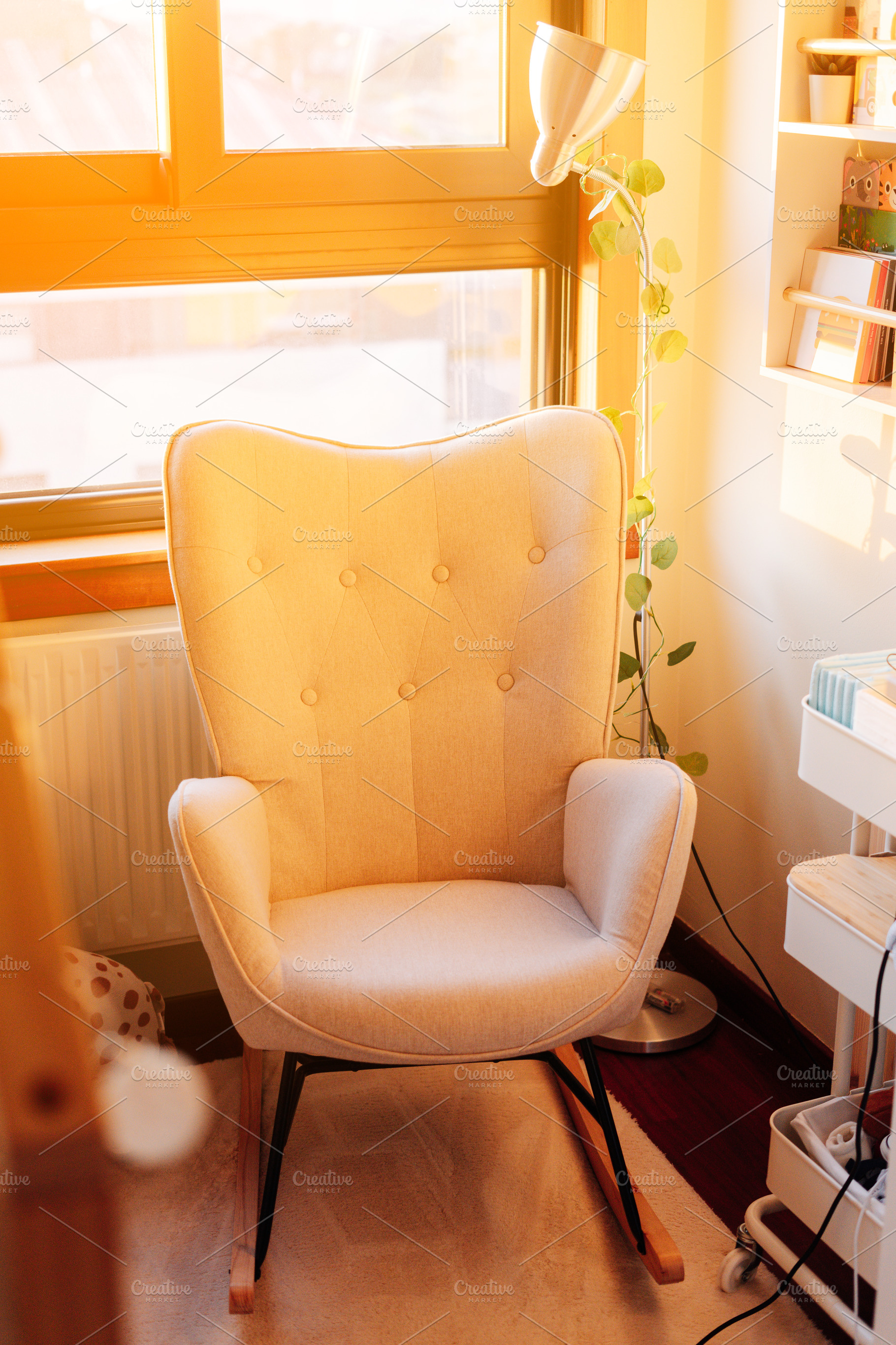 A rocking chair on a baby room at sunset, a Person Photo by rubenchase