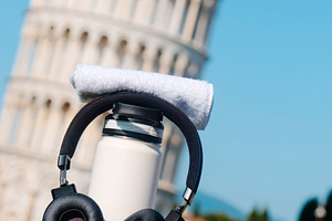 bottle and headphones by the Tower of Pisa, a Photo by Nito
