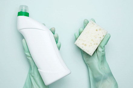 House cleaning. Womans hand in rubber glove holds green dishwashing sponge and, a Photo by matucha