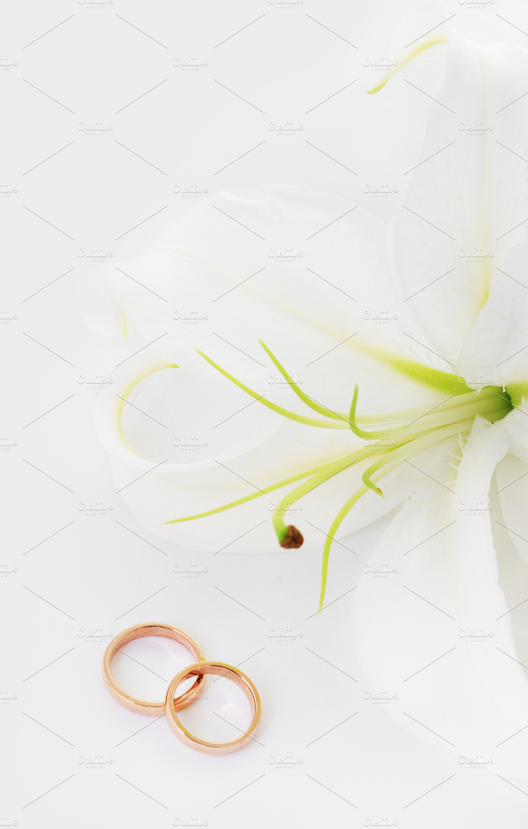 Wedding rings & lily stock photo containing background and beauty, a Holiday Photo by Lenka_X
