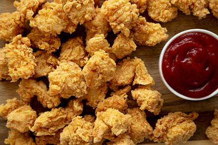 Homemade Crunchy Popcorn Chicken with Ketchup on a Board, top vi, a Food & Drink Photo by LiudmylaChuhunova