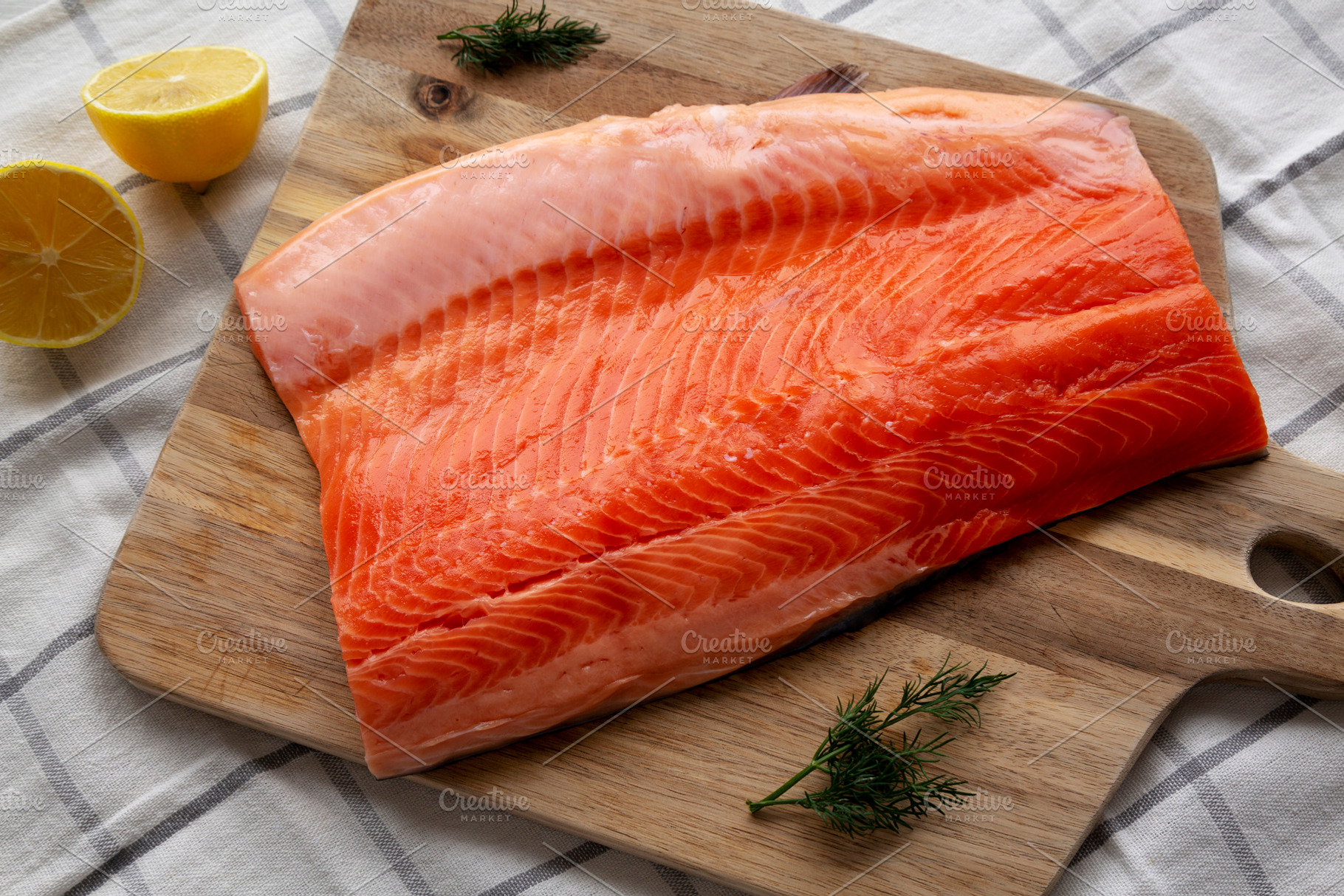 Organic Raw Salmon Fillet on a wooden board, top view. Flat lay,, a Food & Drink Photo by LiudmylaChuhunova