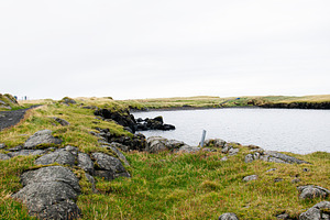 Scenic coastal landscape featuring rocks and grassy shores in Iceland, a Nature Photo by AS photostudio