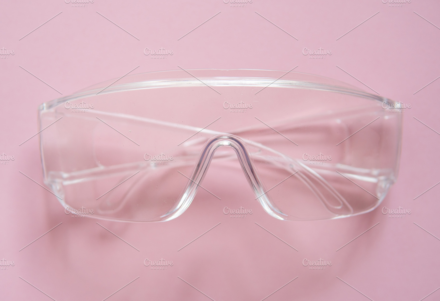Protective glasses lying on a pink containing glasses, white, and safety, a Health & Medical Photo by volodymyrshtun13795