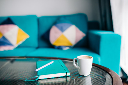 A view of a coffee mug and a journal