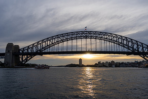 Sydney Harbour Bridge at sunset with golden reflections on the w, an Architecture Photo by GoodGoods