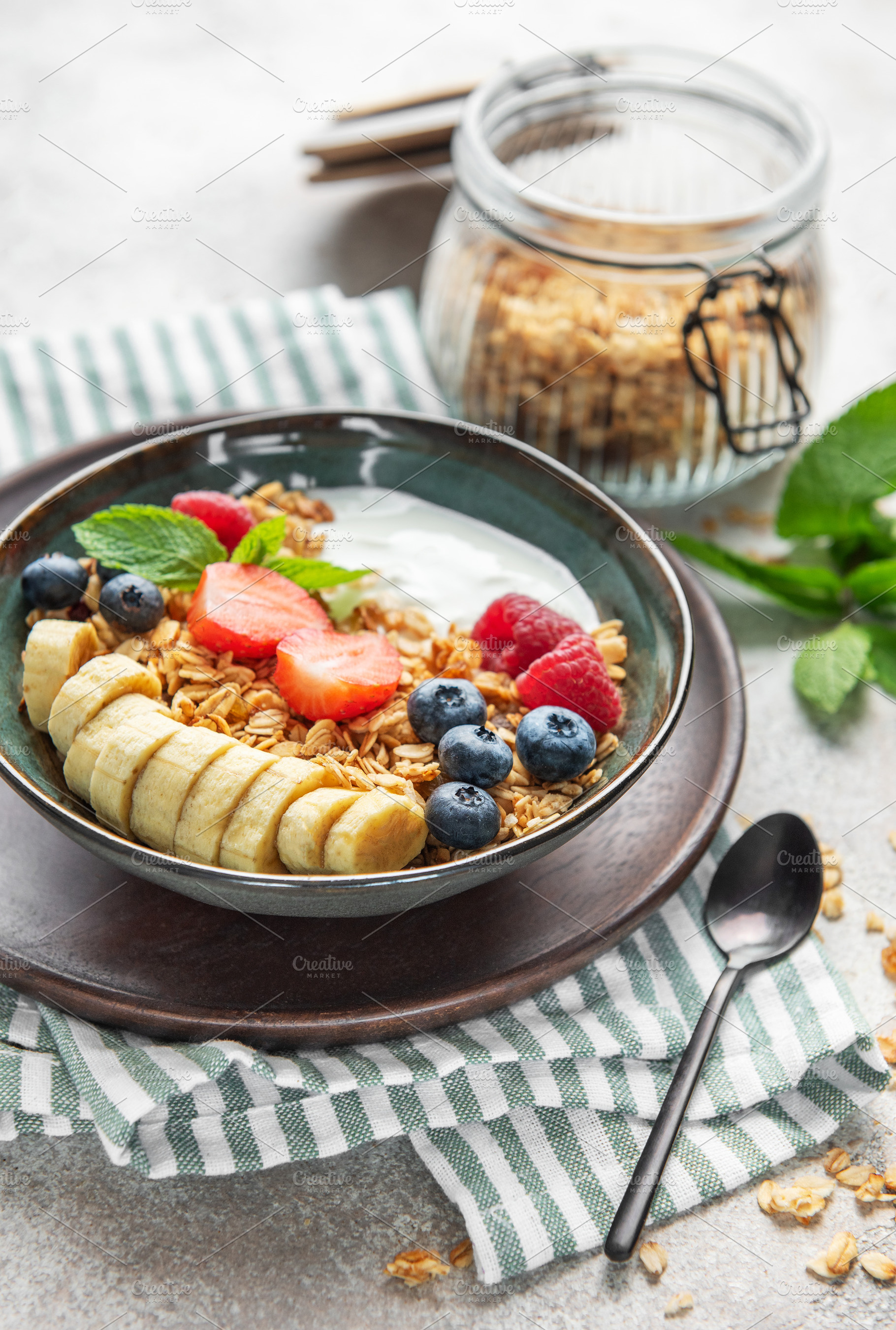 Healthy breakfast bowl with yogurt, granola, banana, and berries, a Food & Drink Photo by Olena Rudo