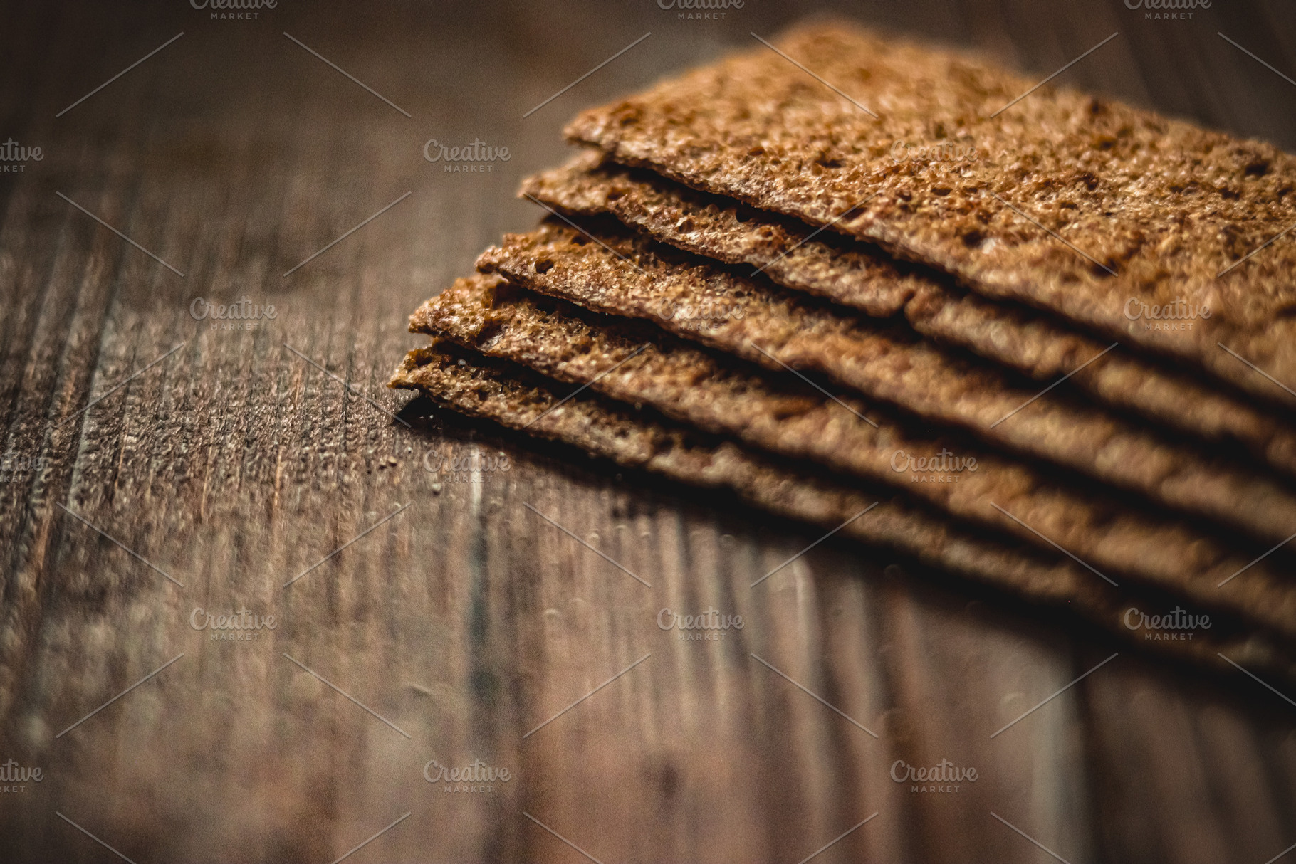 Stack of rye crispbread on a rustic wooden table, healthy diet food background,, a Photo by Studio ANNA