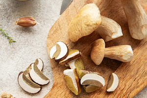 Chef preparing fresh mushrooms with garlic and pepper on cutting, a Food & Drink Photo by Olena Rudo