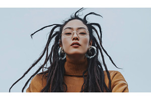 Asian woman with dreadlocks and, a Person Photo by Sergey Kotenev