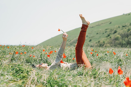 Woman relaxing on flower field.