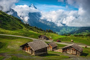 Farmhouses on the green hills, an Architecture Photo by Alpine Dreams