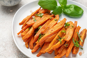 Sweet potato fries with basil, dipping sauce and salt, a Food & Drink Photo by Olena Rudo