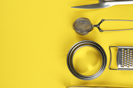 Kitchen utensil on yellow background, space for text, a Food & Drink Photo by AtlasStudio PRO