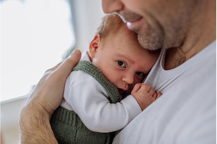 Close-up of father holding his, a Person Photo by HalfPoint