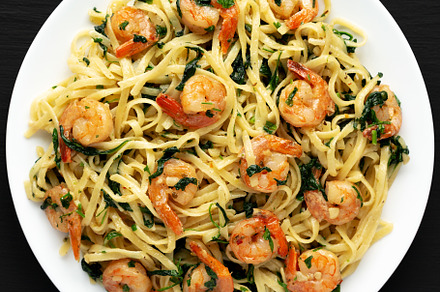 Homemade One-Pot Lemon Garlic Shrimp Pasta on a Plate on a black, a Food & Drink Photo by LiudmylaChuhunova