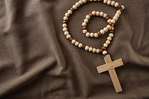 Wooden Rosary with Cross on Fabric Background, a Holiday Photo by Davizro's Market