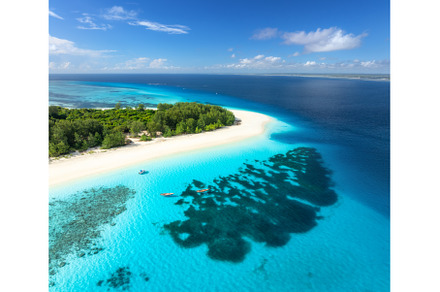 Aerial view of blue sea and Mnemba, a Nature Photo by den-belitsky