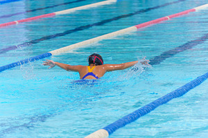 Swimmer child swims butterfly swimming style in a race swimming, a Sports & Recreation Photo by Casanowe-studio