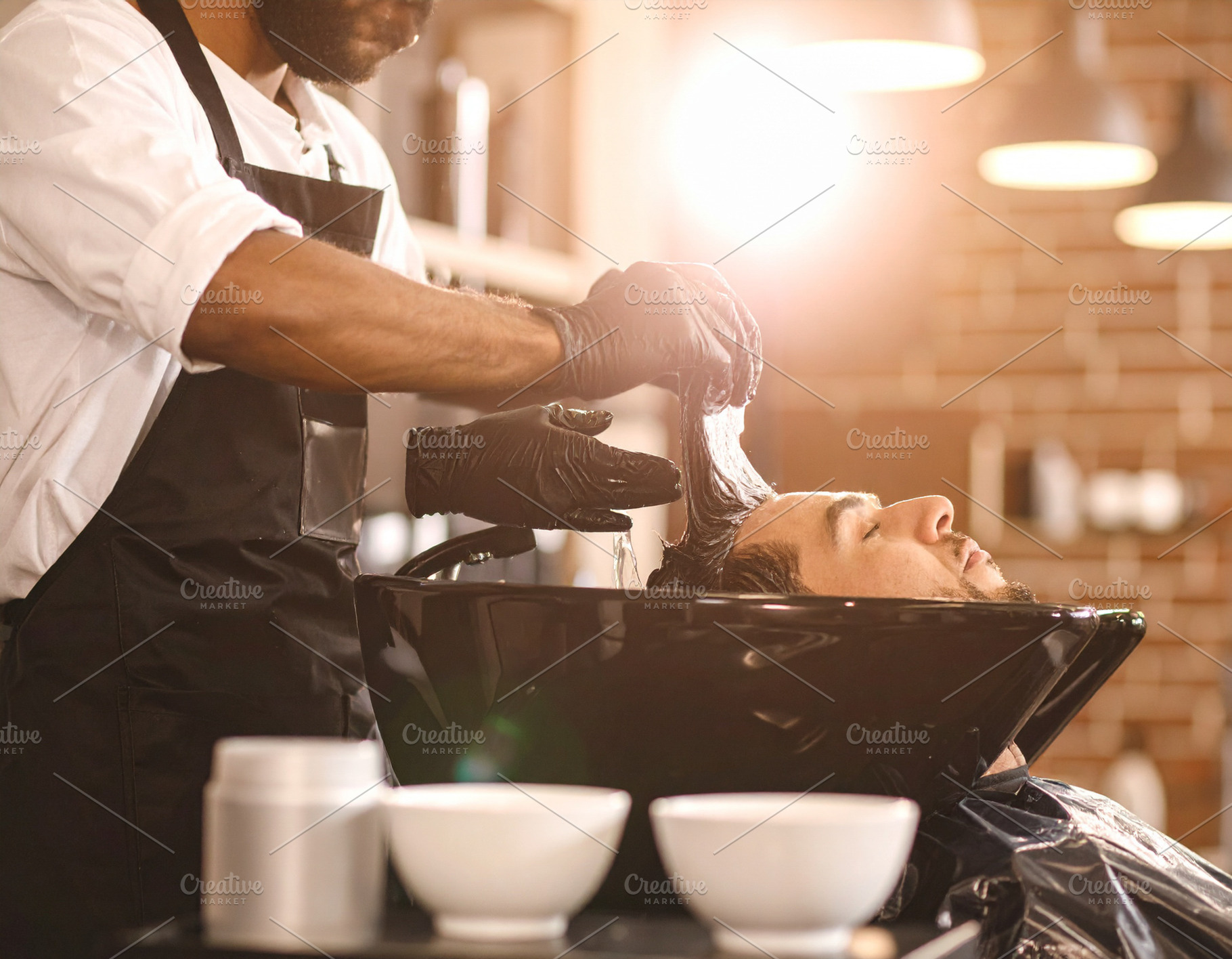 Single stylists hands applying hair color to a client’s hair s, a Beauty & Fashion Photo by DanFLCreativo