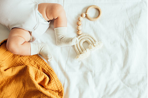 Baby playing with a wooden toy on
