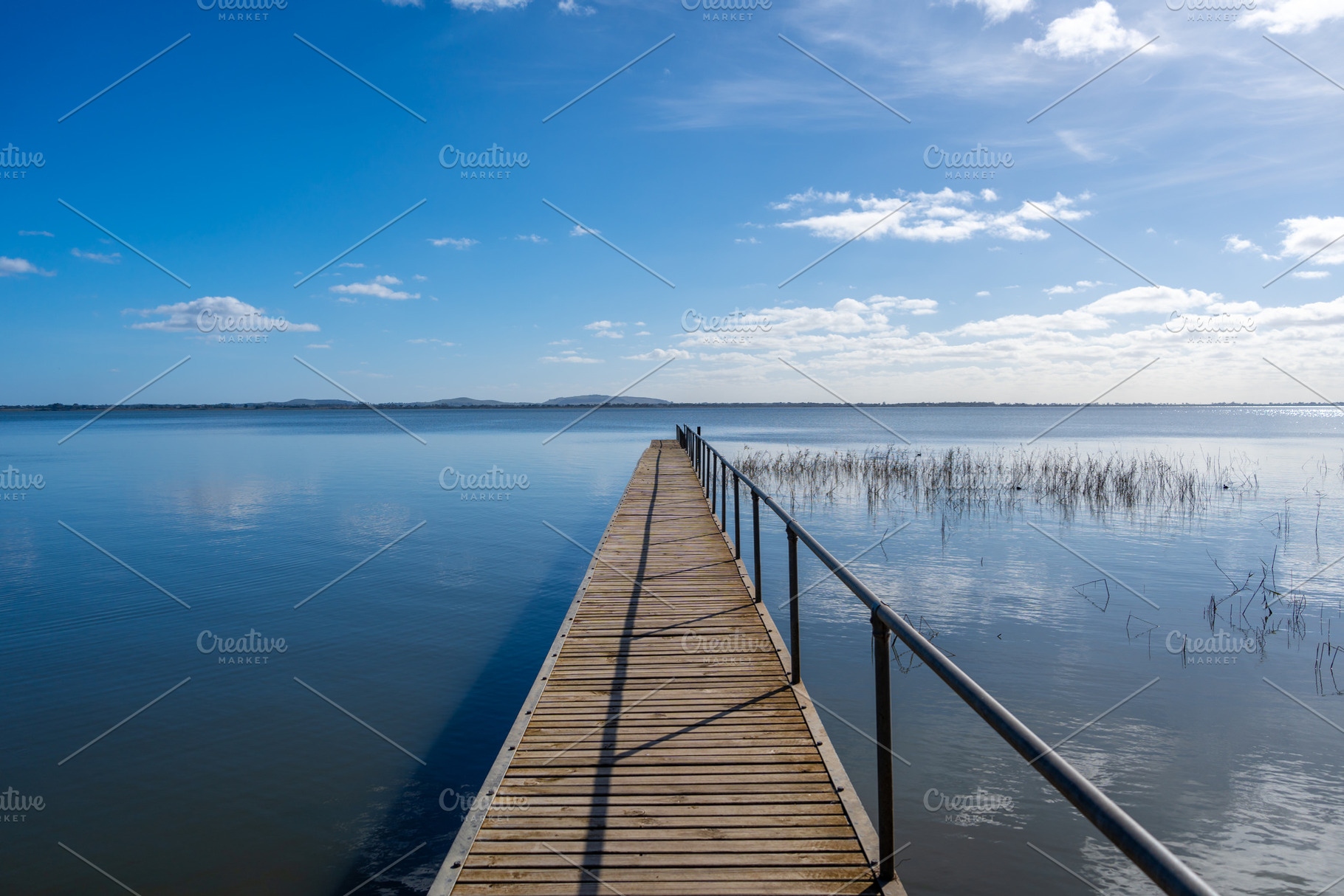 Wooden pier extending over Lake Colac, Victoria, Australia on a, a Nature Photo by GoodGoods