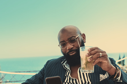 A dapper black man in a street bar, a Person Photo by SkyNext