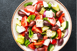 Greek salad in craft plate on black, a Food & Drink Photo by Nadia-nb