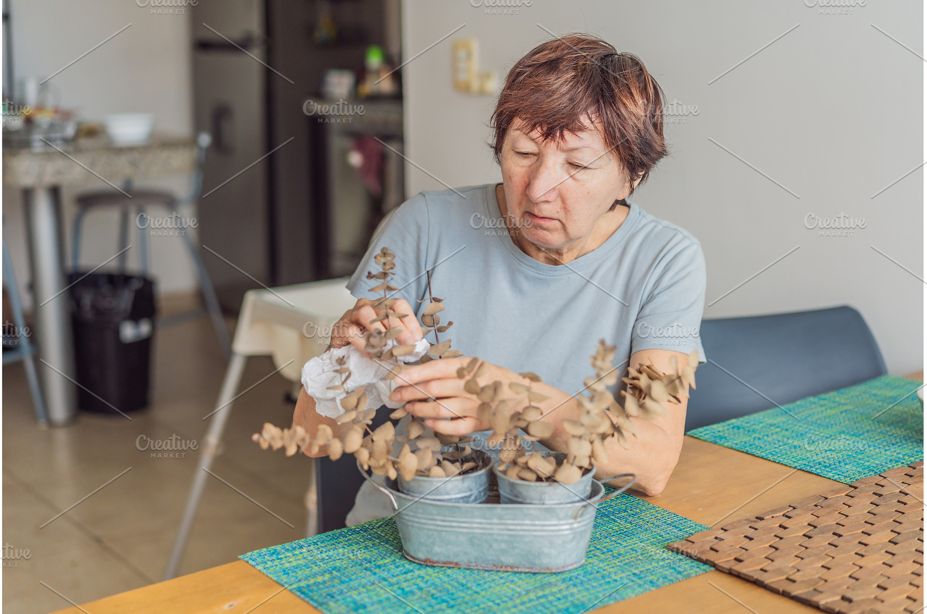 Elderly woman cleaning her home, a Person Photo by Elizaveta Galitskaya