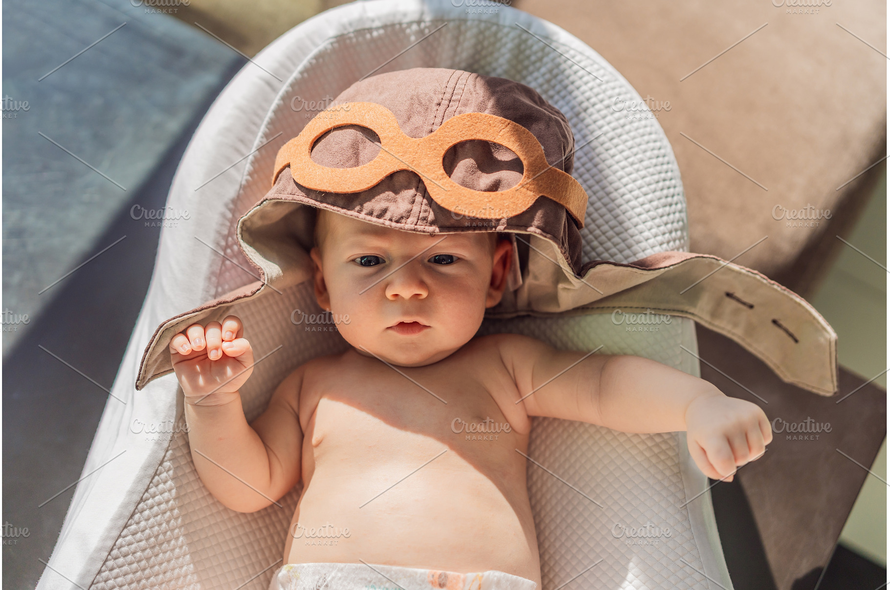 Baby wearing a pilot hat, a Person Photo by Elizaveta Galitskaya