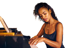 Isolated image of adult woman pianist performing at the piano, an Arts & Entertainment Photo by DanFLCreativo