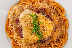 Crispy Chicken Parmesan served over, a Food & Drink Photo by Alexander Prokopenko