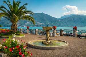 Water fountain and colorful flowers, a Nature Photo by Alpine Dreams