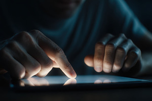 Person uses tablet in dim light, a Photo by Beautiful things