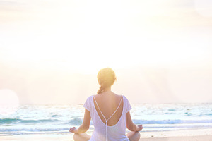 Woman practice yoga at sunrise beach containing woman, summer, and beach