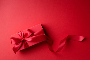 Red gift box on red background.
